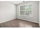 A cozy bedroom features neutral walls and sleek, dark wood-look flooring at 6595 Browns Mill Ferry Dr, Lithonia, GA 30038