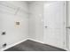 A practical laundry room features modern tile floors and ample storage shelves at 6595 Browns Mill Ferry Dr, Lithonia, GA 30038