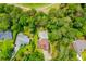 Aerial view of home, pool, backyard firepit, and surrounding mature trees at 7392 N Mitchell N Ct, Villa Rica, GA 30180