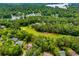 Aerial view of lakefront neighborhood with golf course and mature trees at 7392 N Mitchell N Ct, Villa Rica, GA 30180