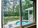 A refreshing backyard pool is framed by a lush, green landscape, promising outdoor relaxation and entertainment at 7392 N Mitchell N Ct, Villa Rica, GA 30180