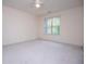 A bright, neutrally decorated bedroom with a large window and plush carpeting for a serene atmosphere at 7392 N Mitchell N Ct, Villa Rica, GA 30180