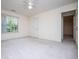 Bright and airy bedroom with neutral carpet, a ceiling fan, and a large window at 7392 N Mitchell N Ct, Villa Rica, GA 30180