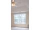 A bedroom view showcasing a window and ceiling fan with a tray ceiling at 7392 N Mitchell N Ct, Villa Rica, GA 30180
