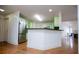 Modern kitchen with stainless steel refrigerator and breakfast bar overlooking the living room at 7392 N Mitchell N Ct, Villa Rica, GA 30180
