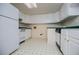 Functional kitchen featuring white appliances, ample cabinet space and tiled floors at 7392 N Mitchell N Ct, Villa Rica, GA 30180