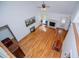 Hardwood-floored living room with high ceiling, fireplace, and view from upstairs at 7392 N Mitchell N Ct, Villa Rica, GA 30180