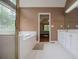 A well-lit bathroom features a soaking tub, a separate shower and a spacious vanity with white cabinets at 7392 N Mitchell N Ct, Villa Rica, GA 30180
