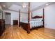 Spacious main bedroom with hardwood floors, vaulted ceiling, and decorative four-poster bed at 7392 N Mitchell N Ct, Villa Rica, GA 30180
