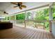 Covered porch with wood flooring, white railings, and ample space for outdoor seating at 7392 N Mitchell N Ct, Villa Rica, GA 30180