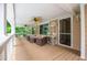 Covered porch with wood flooring, white railings, and ample space for outdoor seating at 7392 N Mitchell N Ct, Villa Rica, GA 30180