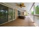 Covered porch with wood flooring, white railings, and ample space for outdoor seating at 7392 N Mitchell N Ct, Villa Rica, GA 30180