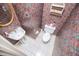 A unique powder room features a pedestal sink, toilet and colorful paisley wallpaper at 7392 N Mitchell N Ct, Villa Rica, GA 30180
