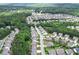 An aerial view of a neighborhood with lush green trees and well-maintained houses creating a serene environment at 302 Aspen Valley Ln, Dallas, GA 30157