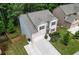 Aerial view of a two-story home with a lush lawn and driveway, in a residential neighborhood at 302 Aspen Valley Ln, Dallas, GA 30157