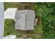 Aerial view of the home's roof, backyard, deck and driveway surrounded by lush greenery at 302 Aspen Valley Ln, Dallas, GA 30157