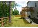 Spacious backyard features a deck, patio and green lawn, perfect for outdoor activities at 302 Aspen Valley Ln, Dallas, GA 30157