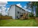 View of a backyard with green grass, fenced perimeter, and the exterior of the home at 302 Aspen Valley Ln, Dallas, GA 30157