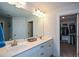 Bright bathroom with double sinks, modern fixtures, and a walk-in closet at 302 Aspen Valley Ln, Dallas, GA 30157