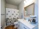 Bathroom with a white vanity, framed mirror, and wood-look flooring at 302 Aspen Valley Ln, Dallas, GA 30157