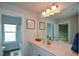 Bright bathroom featuring a white vanity with modern fixtures and framed wall art at 302 Aspen Valley Ln, Dallas, GA 30157