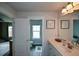 Bright bathroom featuring a white vanity with modern fixtures and framed wall art at 302 Aspen Valley Ln, Dallas, GA 30157