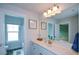Well-lit bathroom with dual framed mirror, white vanity, and luxury vinyl plank flooring at 302 Aspen Valley Ln, Dallas, GA 30157