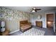 Nicely appointed Bedroom featuring a crib, dresser, floral wall decor, and ceiling fan at 302 Aspen Valley Ln, Dallas, GA 30157