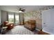 Charming Bedroom with a floral accent wall, crib, chair, and natural light at 302 Aspen Valley Ln, Dallas, GA 30157