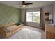 Well-lit Bedroom with a geometric accent wall, toddler bed, and a comfortable rug at 302 Aspen Valley Ln, Dallas, GA 30157
