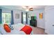 Cozy bedroom featuring neutral walls, plush carpet, ceiling fan and windows with views of the yard at 302 Aspen Valley Ln, Dallas, GA 30157