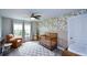 Charming Bedroom with a crib, leather chair, floral wallpaper, and large windows at 302 Aspen Valley Ln, Dallas, GA 30157