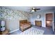 Bright Bedroom with floral wallpaper, carpet, and a wooden changing table at 302 Aspen Valley Ln, Dallas, GA 30157