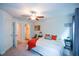 Bright bedroom with a ceiling fan, carpet, and a glimpse into the en-suite bathroom at 302 Aspen Valley Ln, Dallas, GA 30157