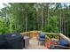 Inviting deck with grill, outdoor seating, and wooded views perfect for relaxing or entertaining guests at 302 Aspen Valley Ln, Dallas, GA 30157