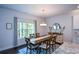 Bright dining room with large window, hardwood floors, and modern chandelier at 302 Aspen Valley Ln, Dallas, GA 30157