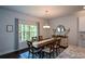 Cozy dining room featuring a wooden table, modern chandelier, and a bright window at 302 Aspen Valley Ln, Dallas, GA 30157