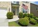 Inviting entrance with American flag, lovely landscaping and front door wreath at 302 Aspen Valley Ln, Dallas, GA 30157