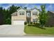 Charming two-story home with a well-manicured lawn and attached two-car garage at 302 Aspen Valley Ln, Dallas, GA 30157
