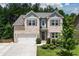 Charming two-story home with a well-manicured lawn and attached two-car garage at 302 Aspen Valley Ln, Dallas, GA 30157