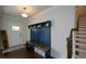 Inviting foyer with custom mudroom build-ins and staircase at 302 Aspen Valley Ln, Dallas, GA 30157