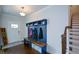 Inviting foyer with hardwood floors, a built-in bench, and staircase at 302 Aspen Valley Ln, Dallas, GA 30157