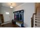 Inviting foyer with custom mudroom build-ins and staircase at 302 Aspen Valley Ln, Dallas, GA 30157