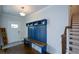 Inviting foyer with hardwood floors, a built-in bench, and staircase at 302 Aspen Valley Ln, Dallas, GA 30157