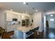 Modern kitchen features stainless steel appliances, granite counters and island with barstool seating at 302 Aspen Valley Ln, Dallas, GA 30157