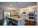 Bright kitchen featuring granite counters, stainless appliances, and an island with bar seating at 302 Aspen Valley Ln, Dallas, GA 30157