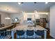 Well-lit kitchen with granite countertops, stainless steel appliances, and an island with bar stools at 302 Aspen Valley Ln, Dallas, GA 30157