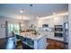 Modern kitchen with a large island, granite countertops, and stainless steel appliances at 302 Aspen Valley Ln, Dallas, GA 30157