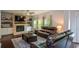 Comfortable living room with brick fireplace, built-in shelving and plush leather seating at 302 Aspen Valley Ln, Dallas, GA 30157