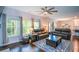 Bright living room with large windows, hardwood floors, and comfortable leather sofas at 302 Aspen Valley Ln, Dallas, GA 30157